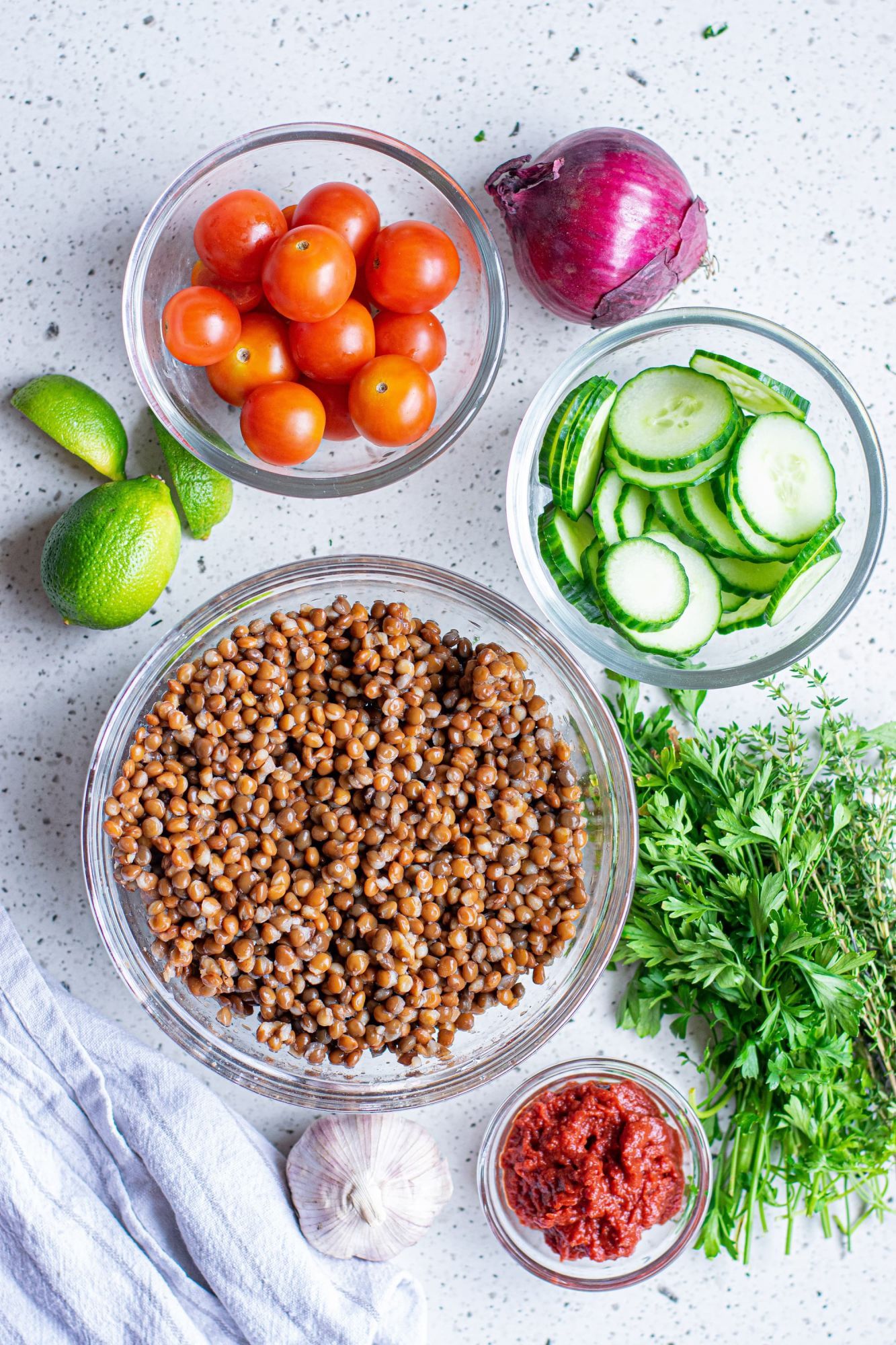 Ingredients for lentil meatballs including canned lentils, tomato paste, parsley, onion, flour, and spices.