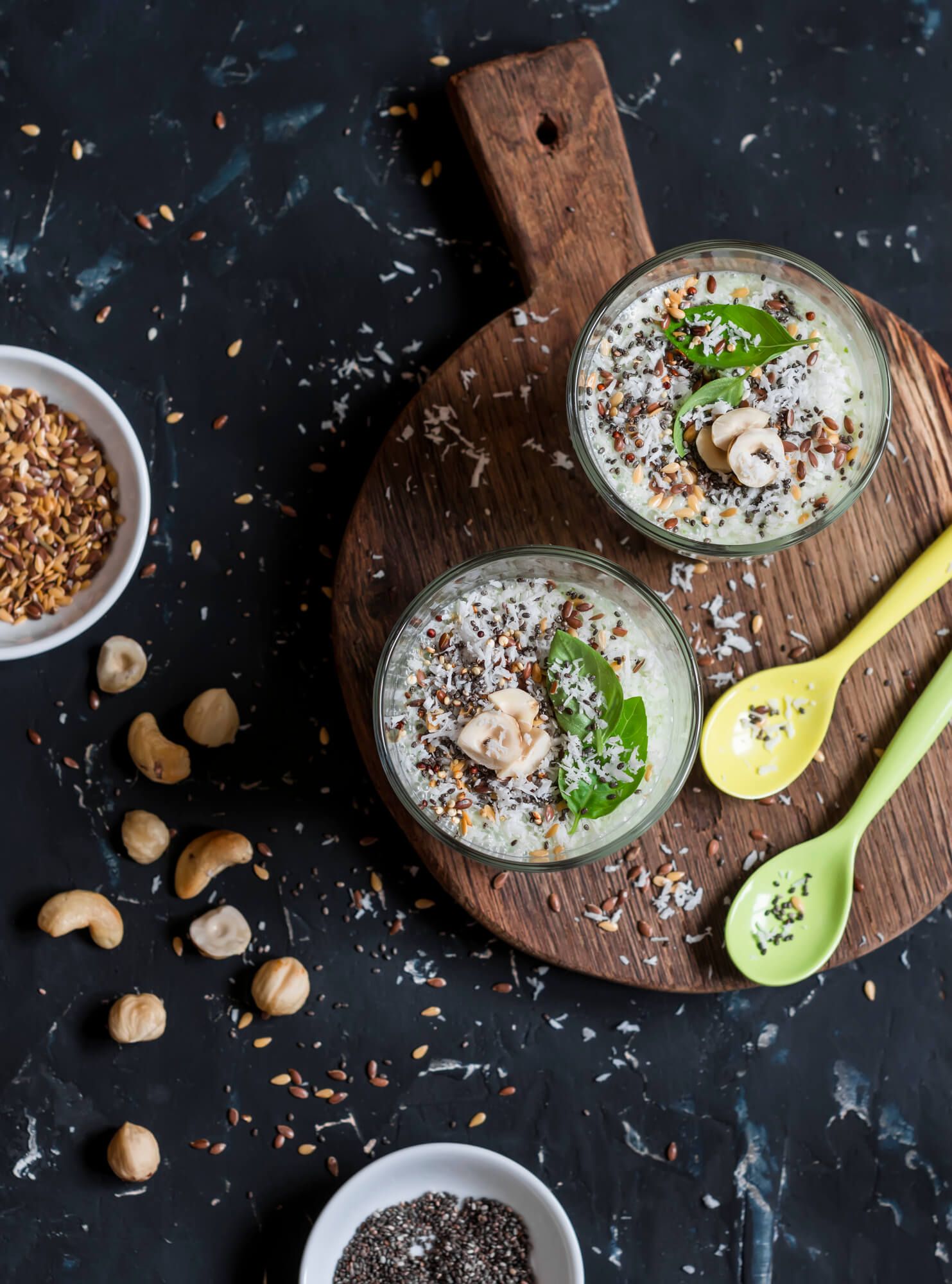 Low carb cereal in a bowl with cashews, chia seeds, and a wooden spoon.