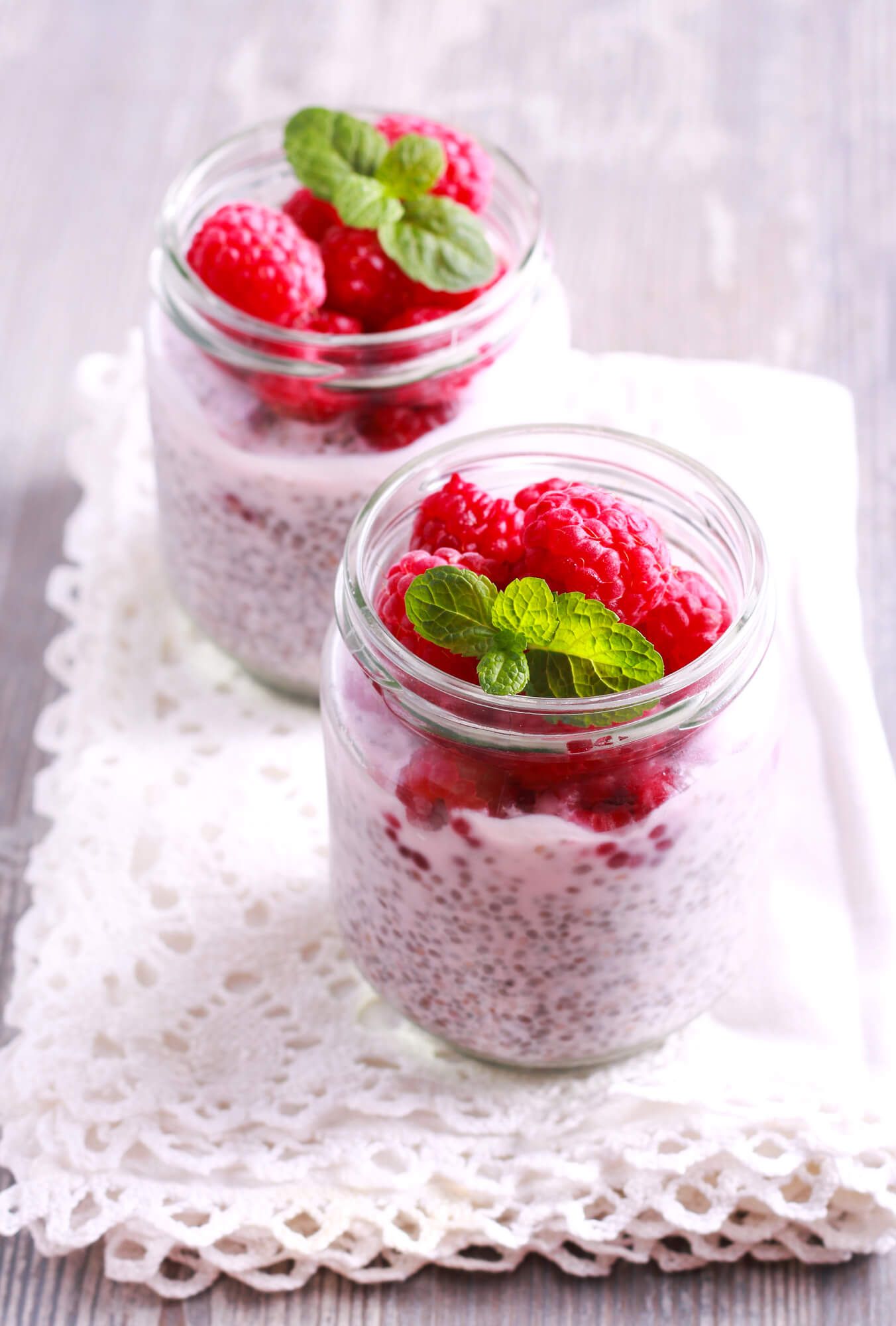 Low carb oatmeal in a glass jar with raspberries on top.