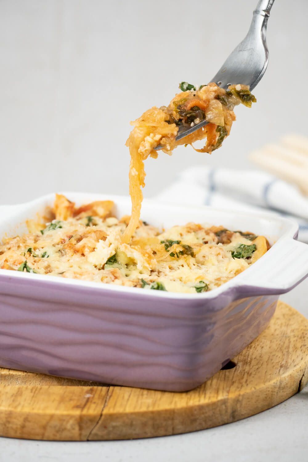 Turkey and spaghetti squash in a casserole dish with a fork lifting out a bite.