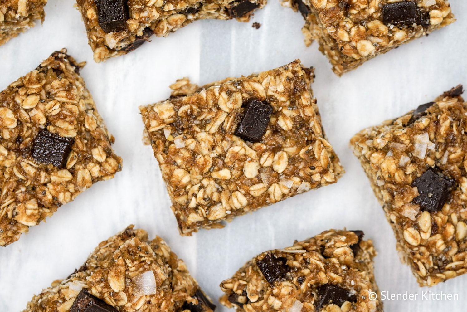 No Bake Oatmeal Bars on parchment paper cut into slices.