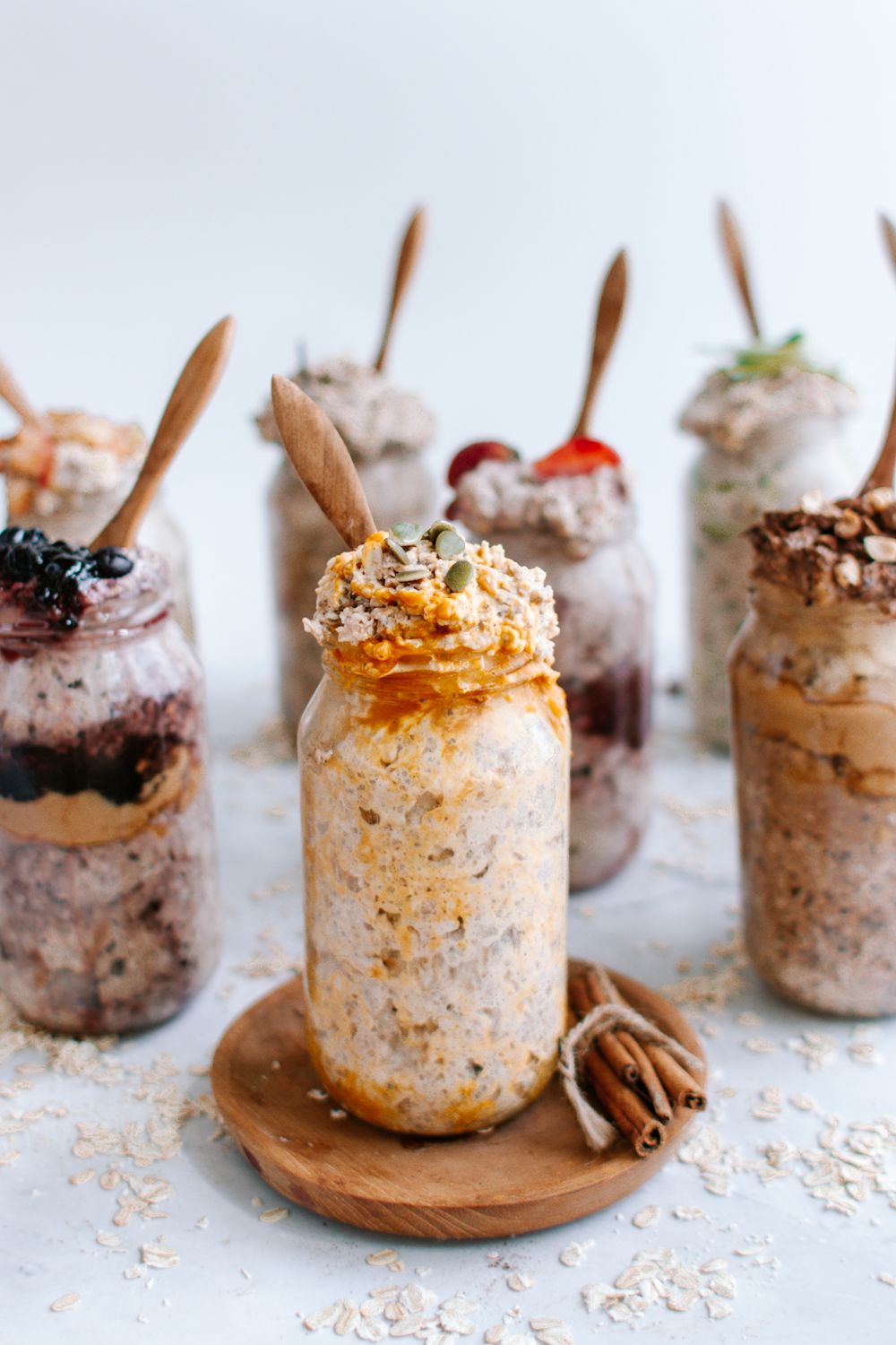 Overnight oats with pumpkin spices in a mason jar with more oatmeal in the background.