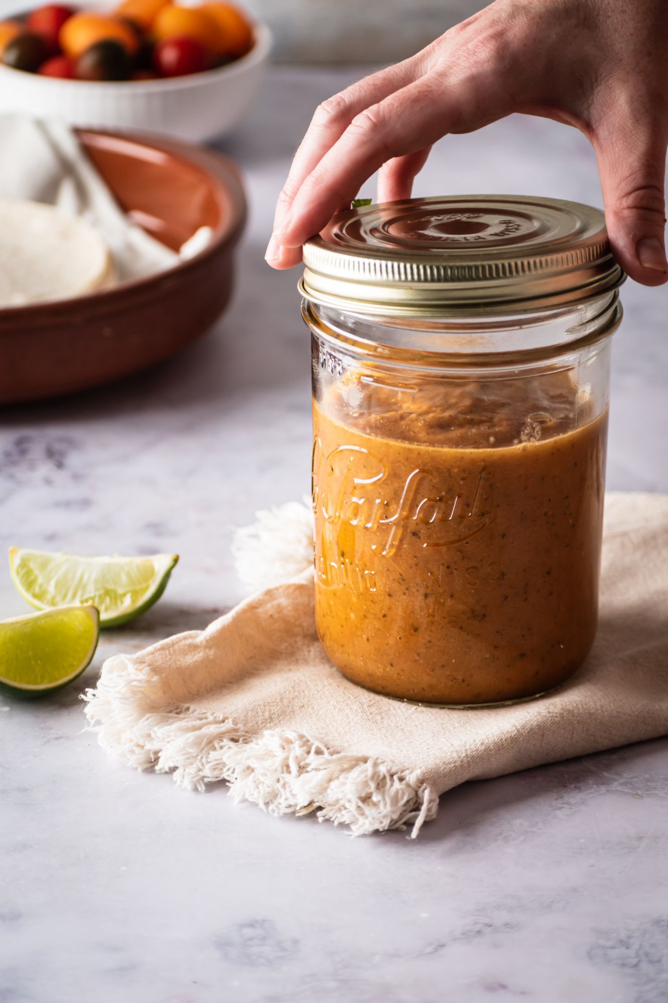 Authentic ranchero sauce in a glass jar with blended tomatoes, jalapeno, onion, and spices.