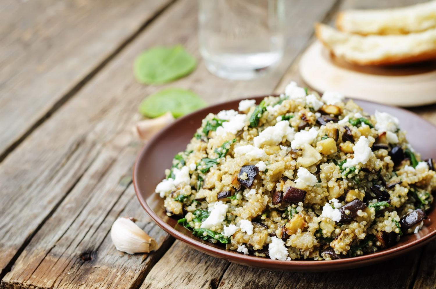 Quinoa recipe featuring a salad with eggplant and feta.