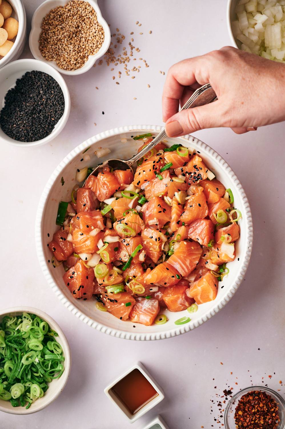 Hawaiian salmon poke with raw salmon tossed in soy poke sauce with green onions and sesame seeds.