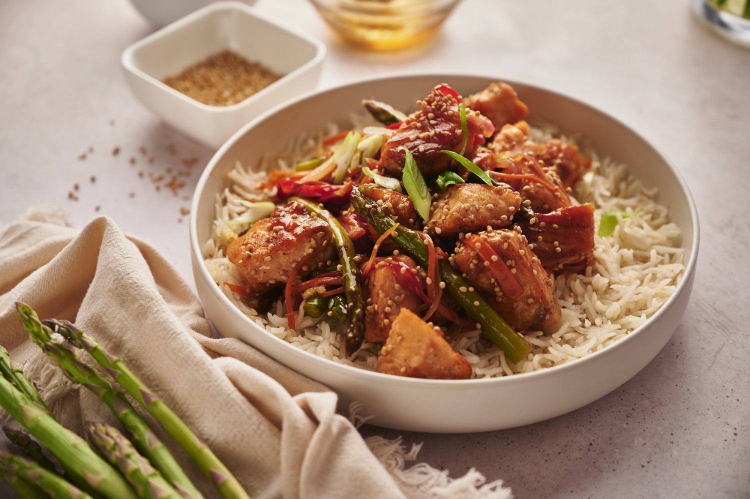 Easy salmon stir fry with fresh vegetables and teriyaki sauce served over white rice.