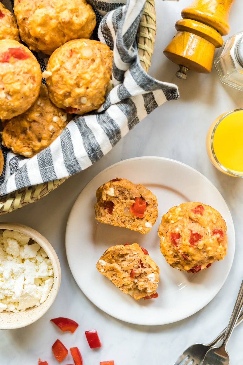 Red pepper and feta cheese muffins with whole wheat flour served on a plate with cheese and peppers on the side.