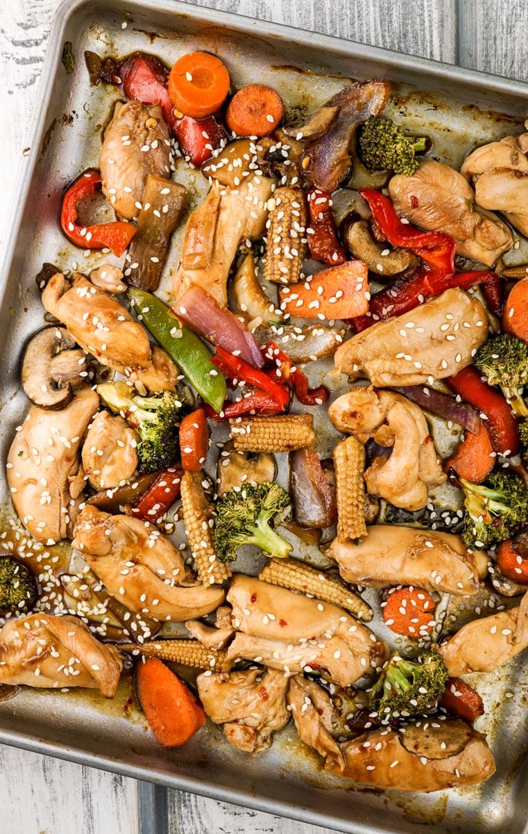 Sheet Pan Asian Chicken Stir Fry just out of the oven with sesame seeds.