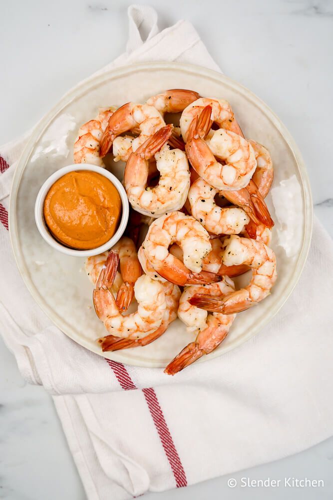 Easy shrimp cocktail with the tails on and a bowl of cocktail sauce.