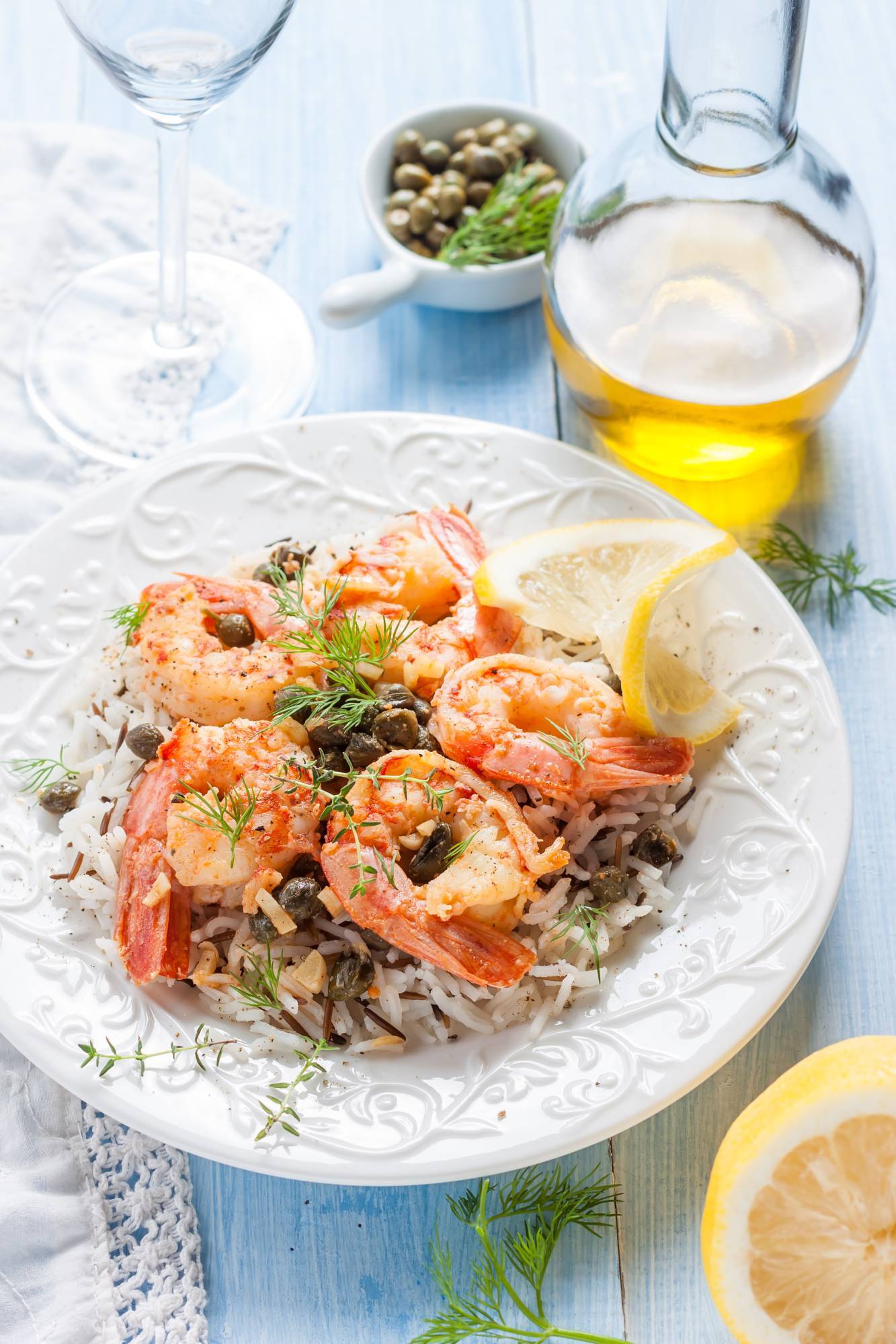 Easy shrimp piccata with rice, lemon, and capers on a plate.