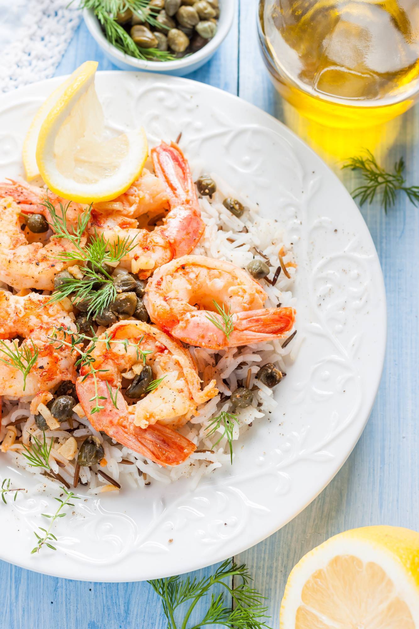 Italian shrimp piccata with capers, lemon, and a butter and white wine sauce over rice.