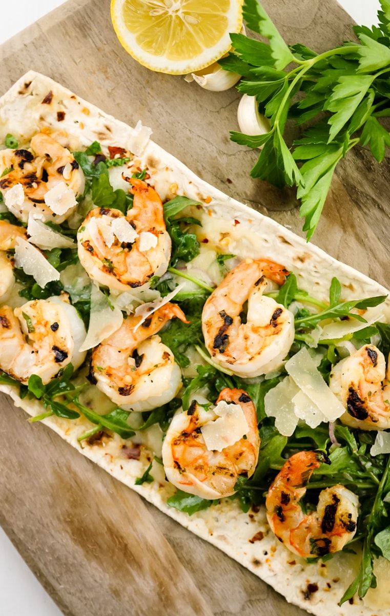 Shrimp Scampi Flatbread ready to be served and cut into slices.