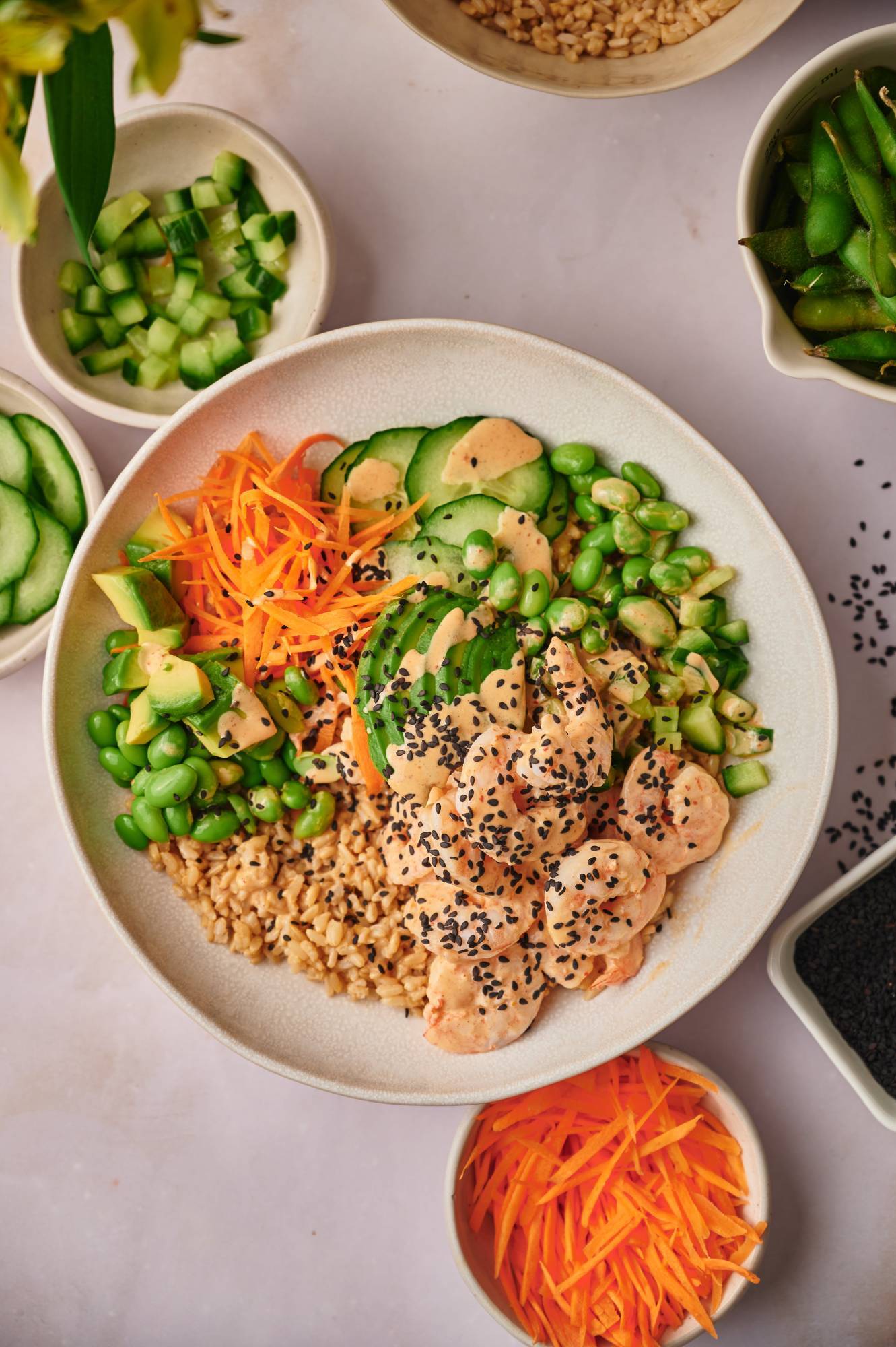 Spicy Shrimp Sushi Bowls in a wooden dish with sesame seeds and seaweed.