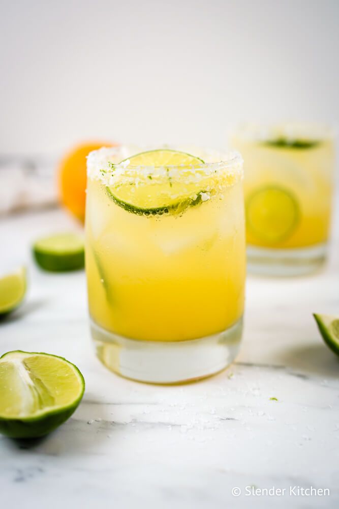 Homemade skinny margaritas made with fresh orange juice, lime juice, and tequila in a glass with a salt rim.