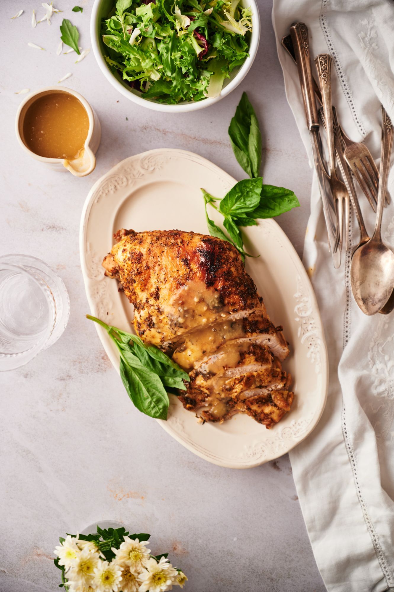 Slow cooker boneless turkey breast cooked with herbs and a crispy skin served with gravy and salad.