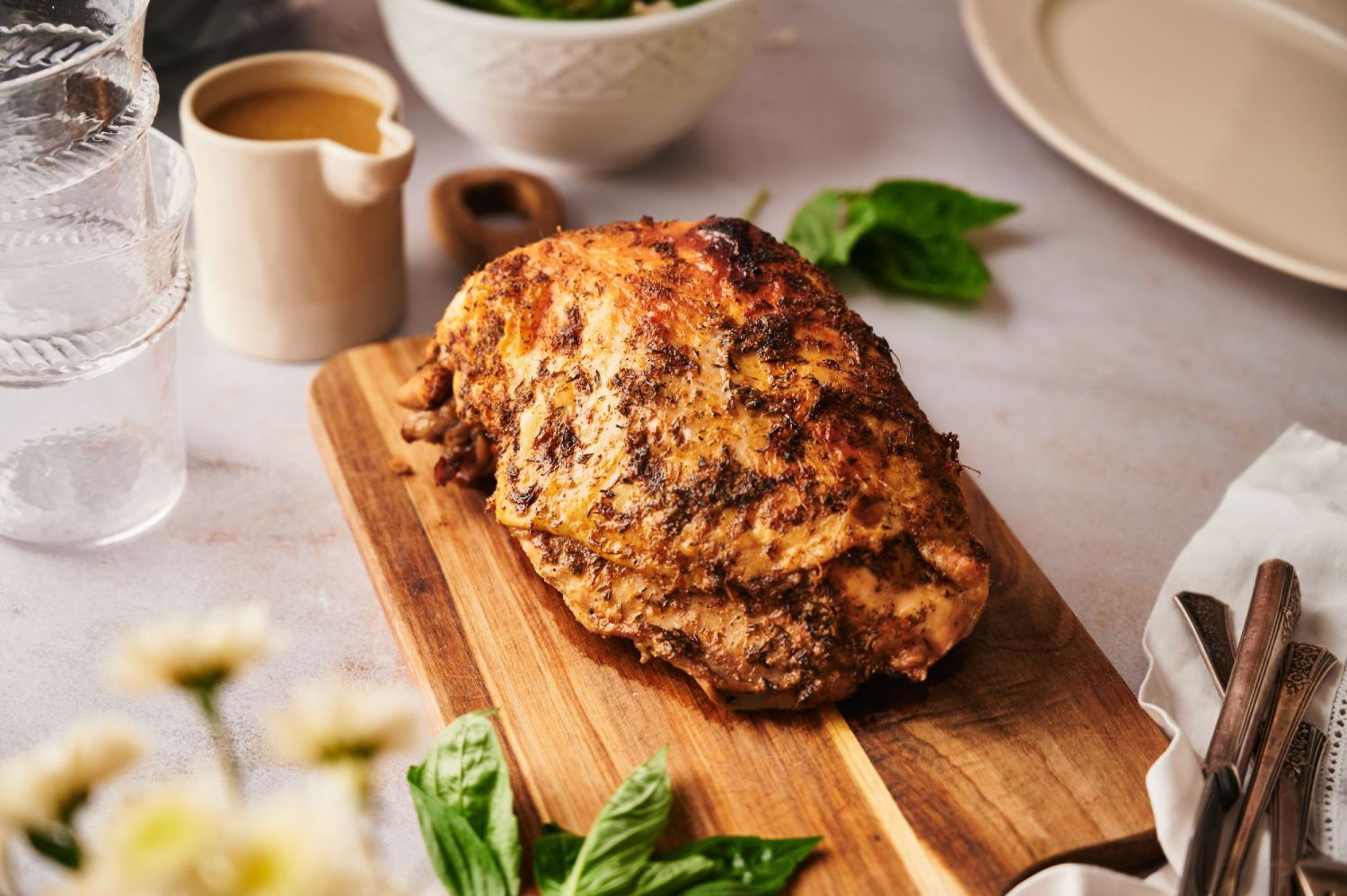 Crockpot turkey breast served on wooden cutting board with crispy skin.