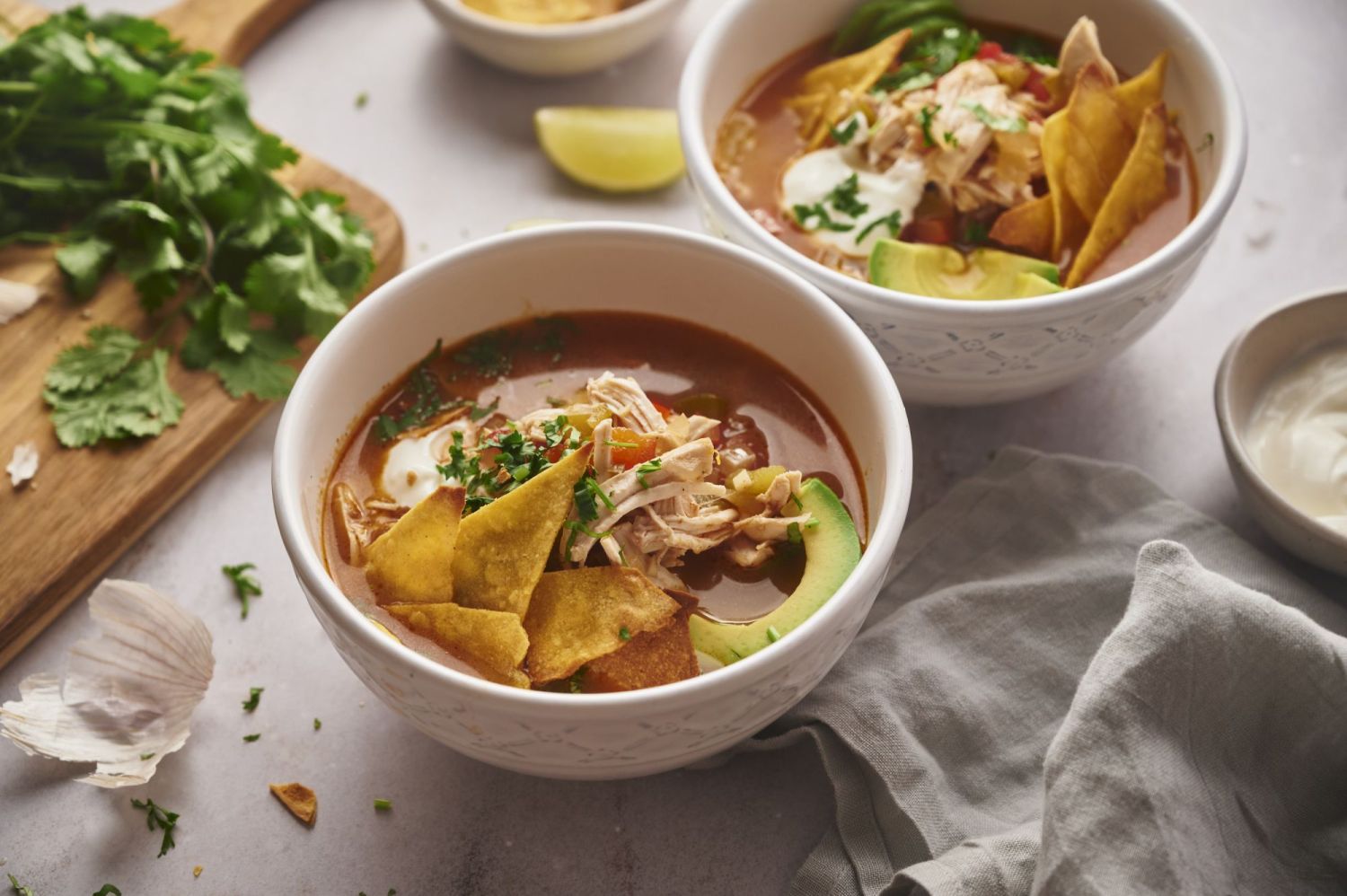 Fajita soup with chicken, bell peppers, tomatoes, onions, cilantro, and tortilla chips.