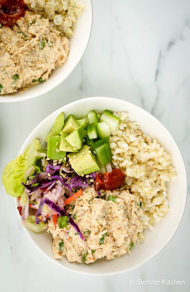 Spicy tuna with brown rice, Sriracha, avocado, and cucumber in a bowl with rice.