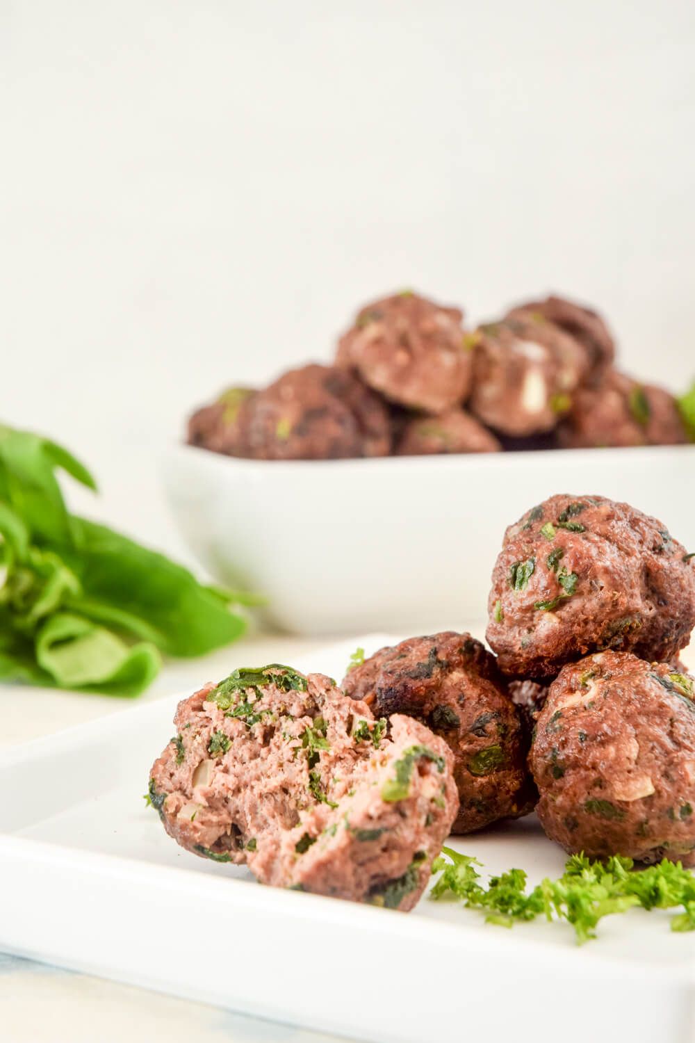 Healthy meatballs made with beef and spinach piled on a plate.