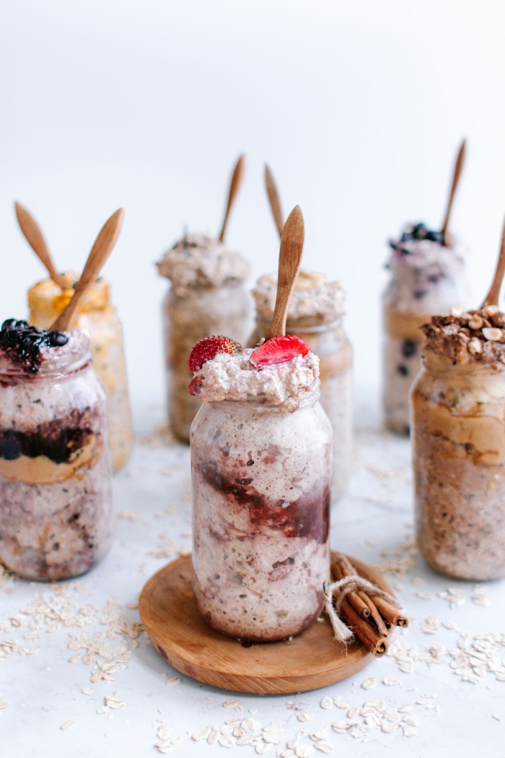 Strawberry overnight oats with strawberry jam, rolled oats, and fresh strawberries in a mason jar.