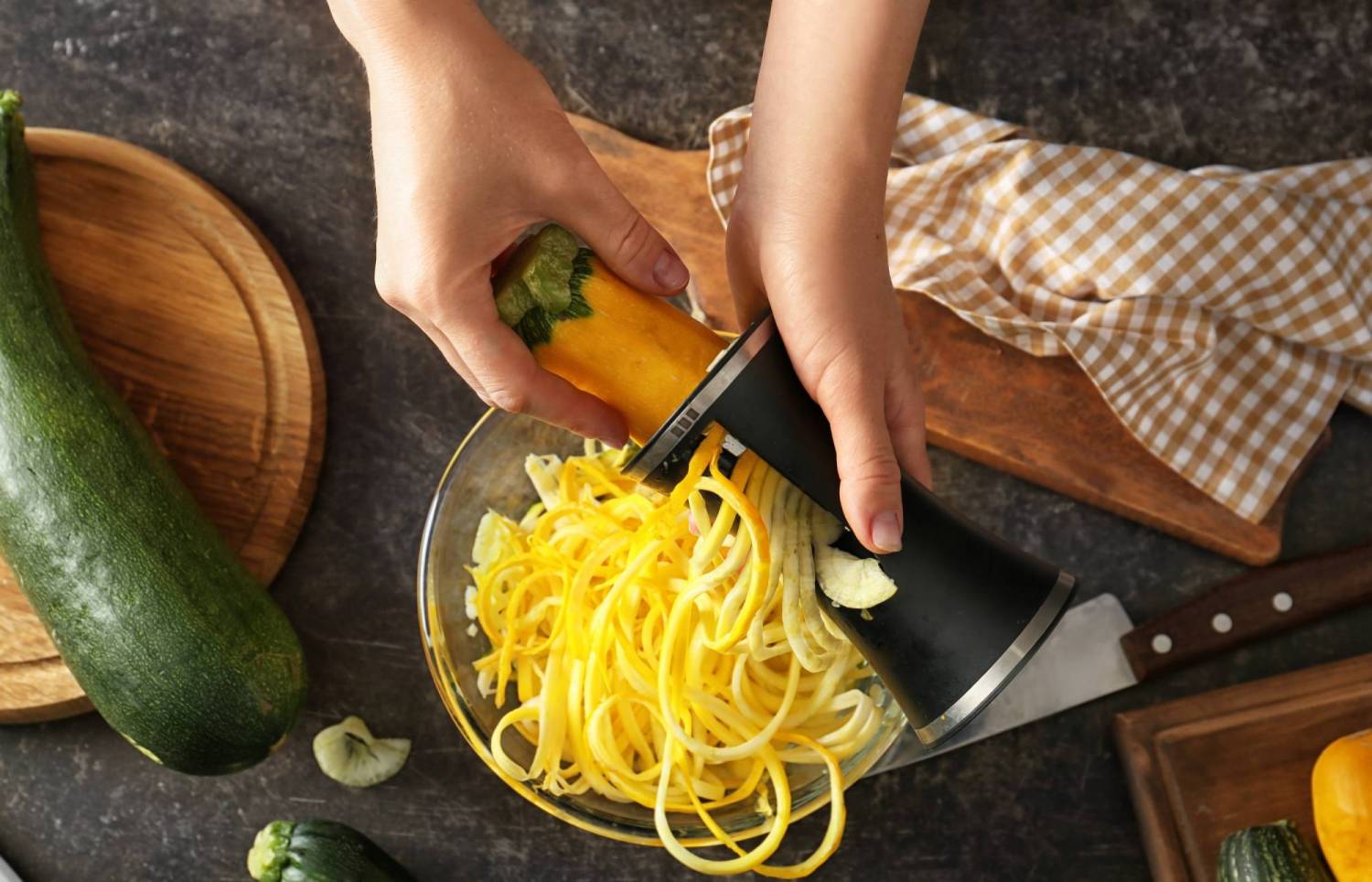 How to make summer squash noodles with a hand held spiralizer.