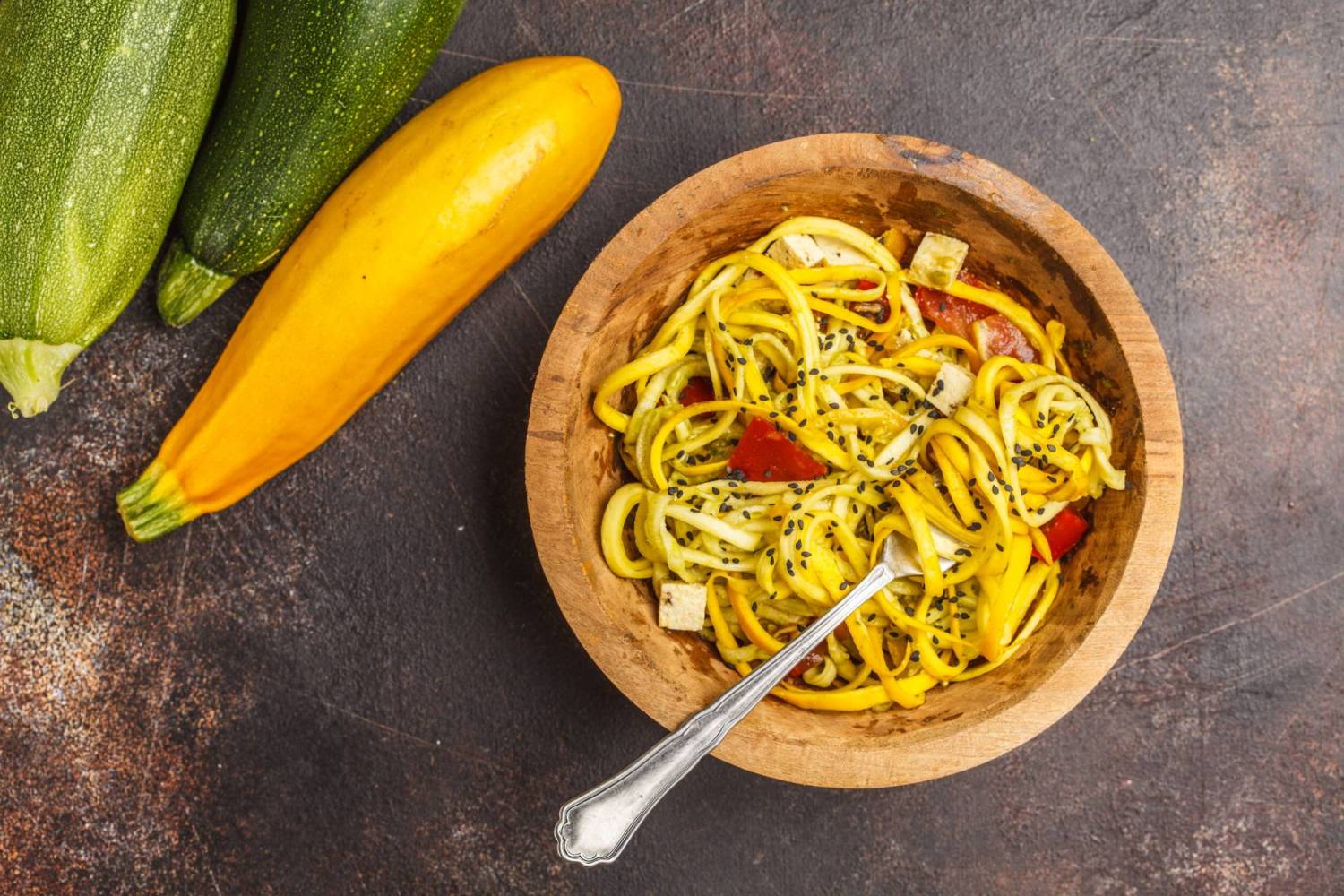 Noodles made with summer squash served with tomatoes, chicken, and sesame seeds. 