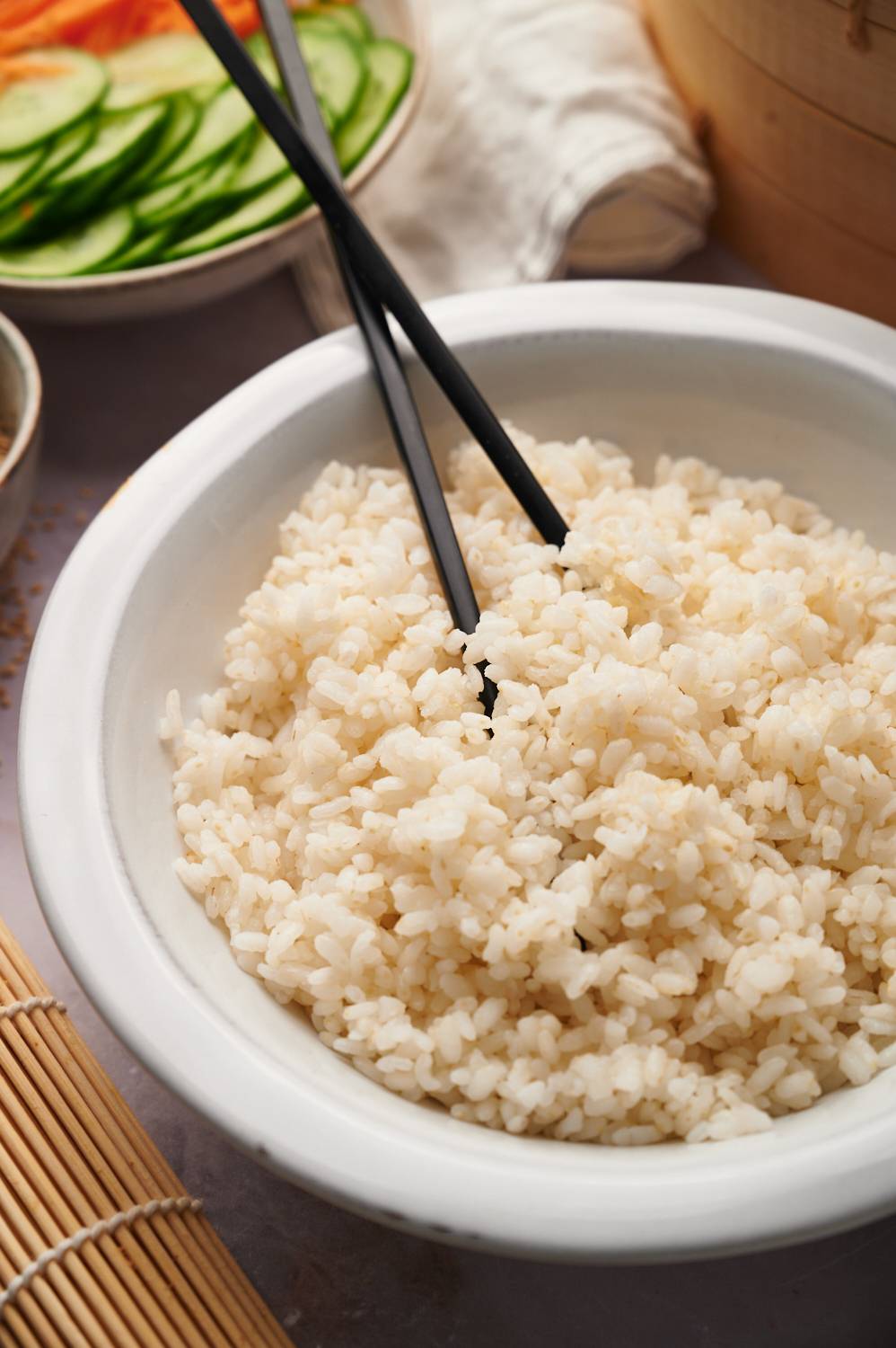 Japanese sushi rice with short grain white rice with rice vinegar served with chopsticks.