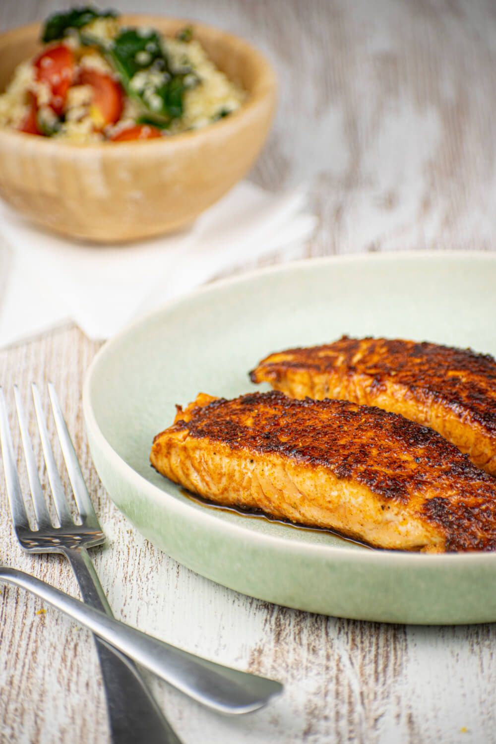 Sweet Spicy salmon with a spice rub crust and a quinoa salad on the side.