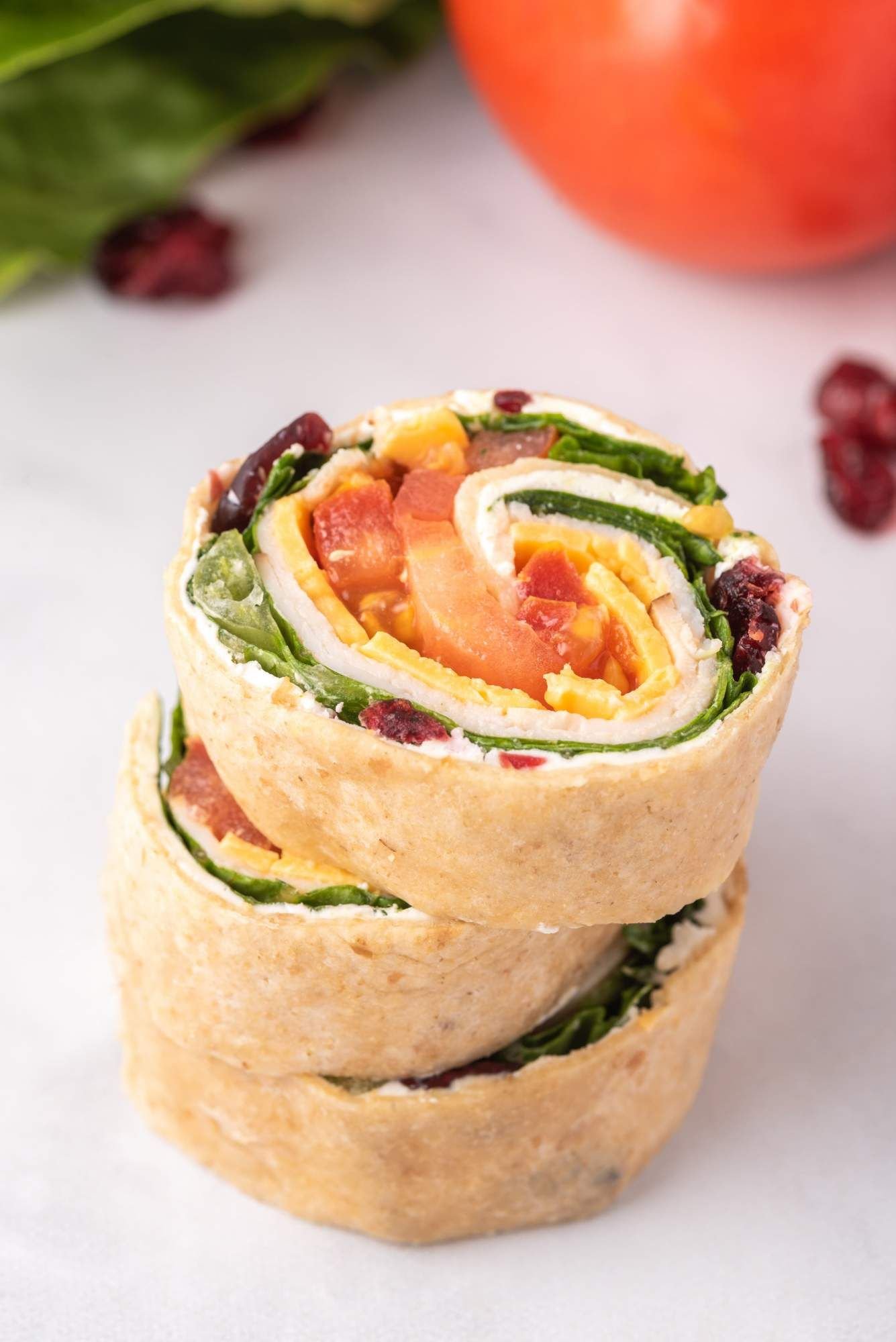 Pinwheels with deli turkey, cream cheese, cranberries, and lettuce wrapped in a tortilla.