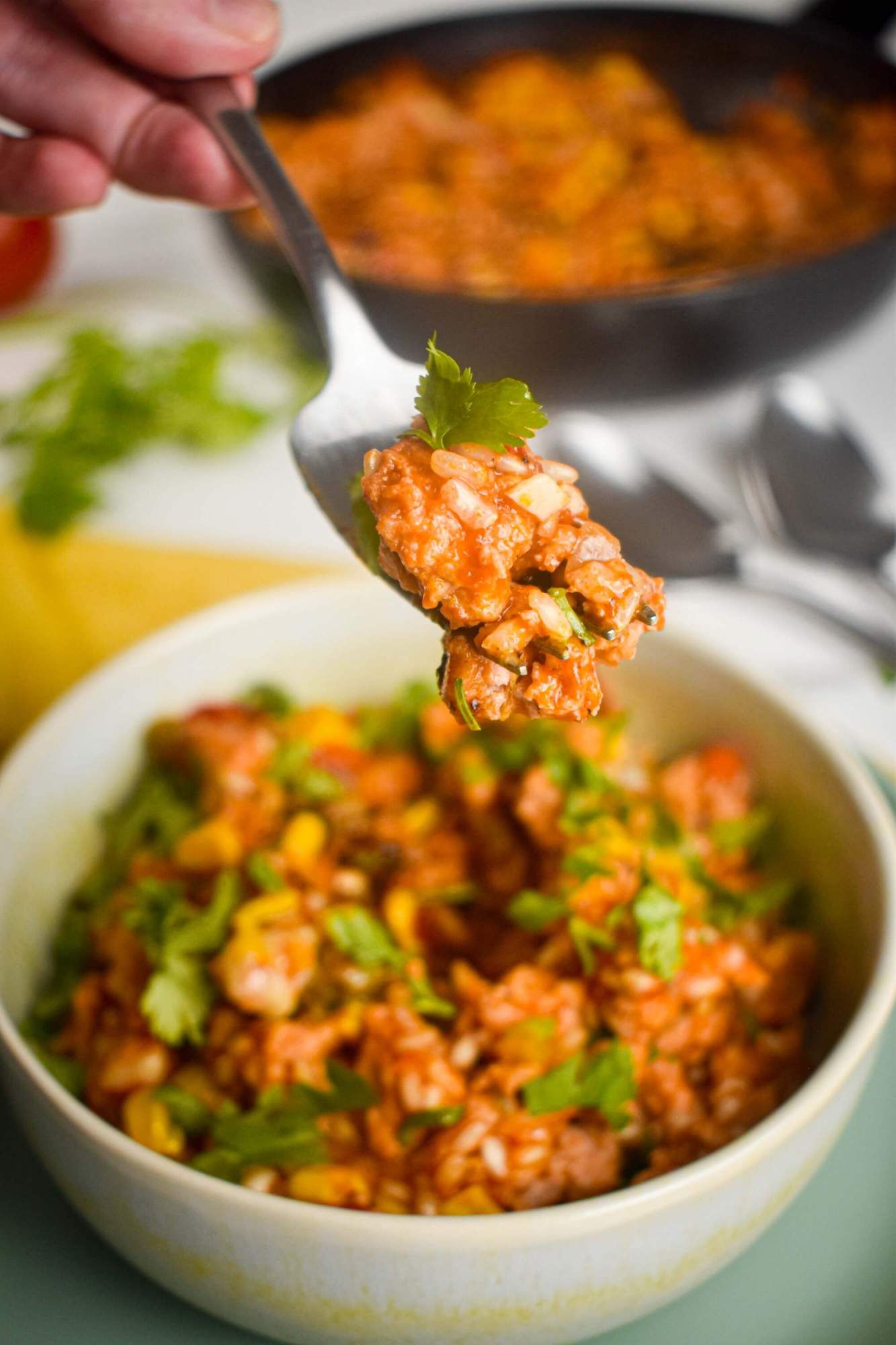 Ground turkey taco skillet with brown rice being picked up with a fork.