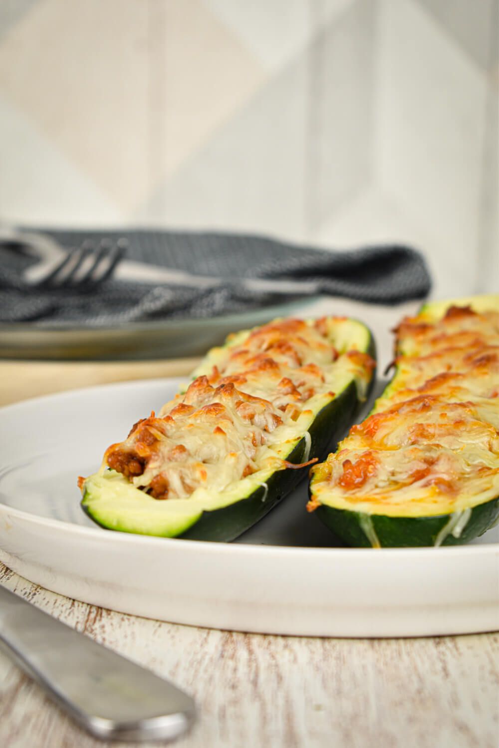 Zucchini Pizzas in hollowed out zucchini with turkey, cheese, marinara sauce, and mushrooms.