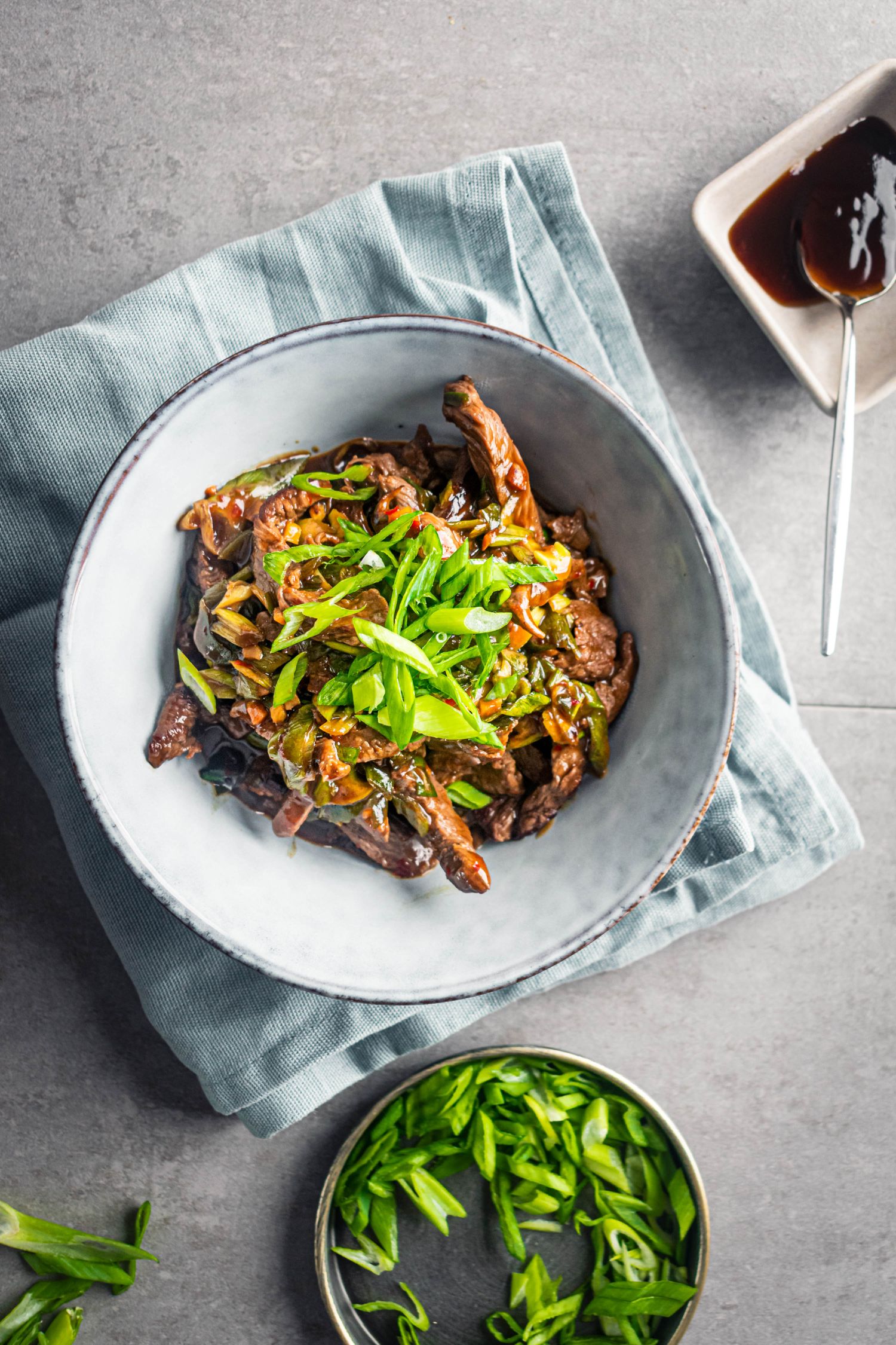 Chinese Mongolian beef with stir fried beef strips in a thick stir fry sauce with green onions.