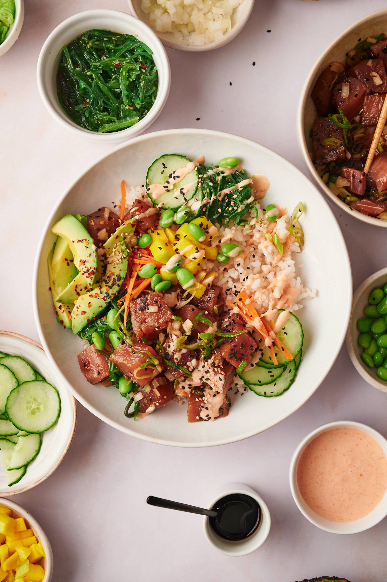 Ahi tuna poke bowls with edamame, carrots, cucumbers, seaweed, and spicy mayo.