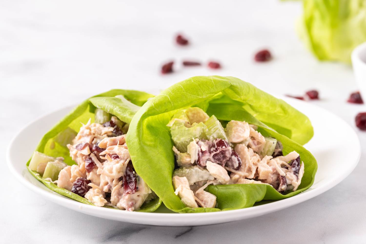 Chicken salad with cranberries wrapped in butter lettuce leaves.