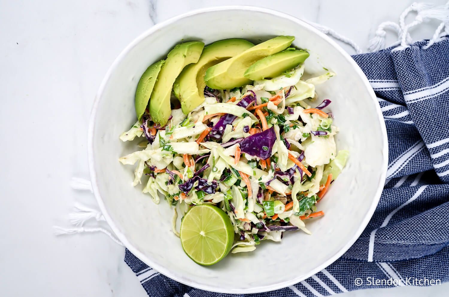 Creamy Mexican coleslaw with cabbage, avocado, cilantro, and a creamy lime yogurt dressing.