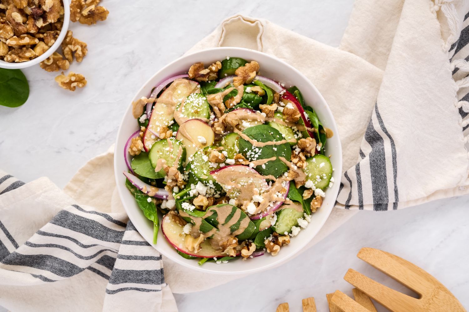 Spinach salad with creamy balsamic vinaigrette, fresh spinach, cucumbers, pears, and red onions.