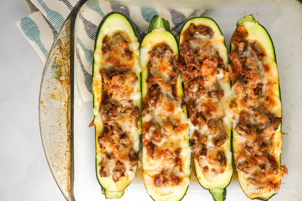 Zucchini Turkey Pizza Boats with melted cheese in a glass baking dish.