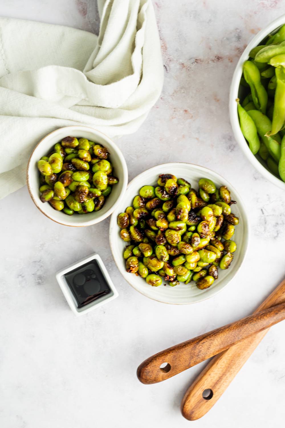 Sautéed soy beans in a bowl with garlic and soy sauce.