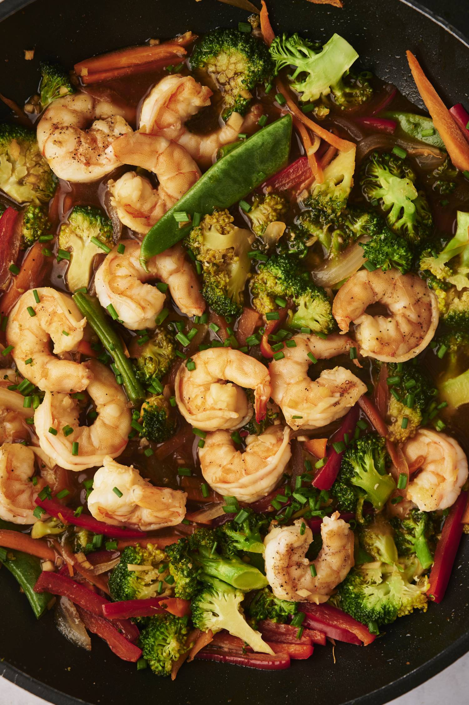 Shrimp stir fry with broccoli, red bell peppers, carrots, snap peas, and homemade soy stir fry sauce.