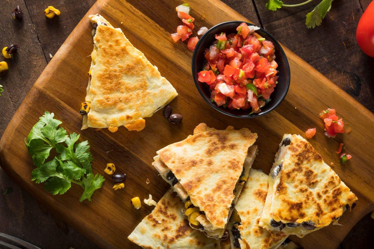 Chicken and cheese quesadillas with black beans, corn, and pico de gallo.