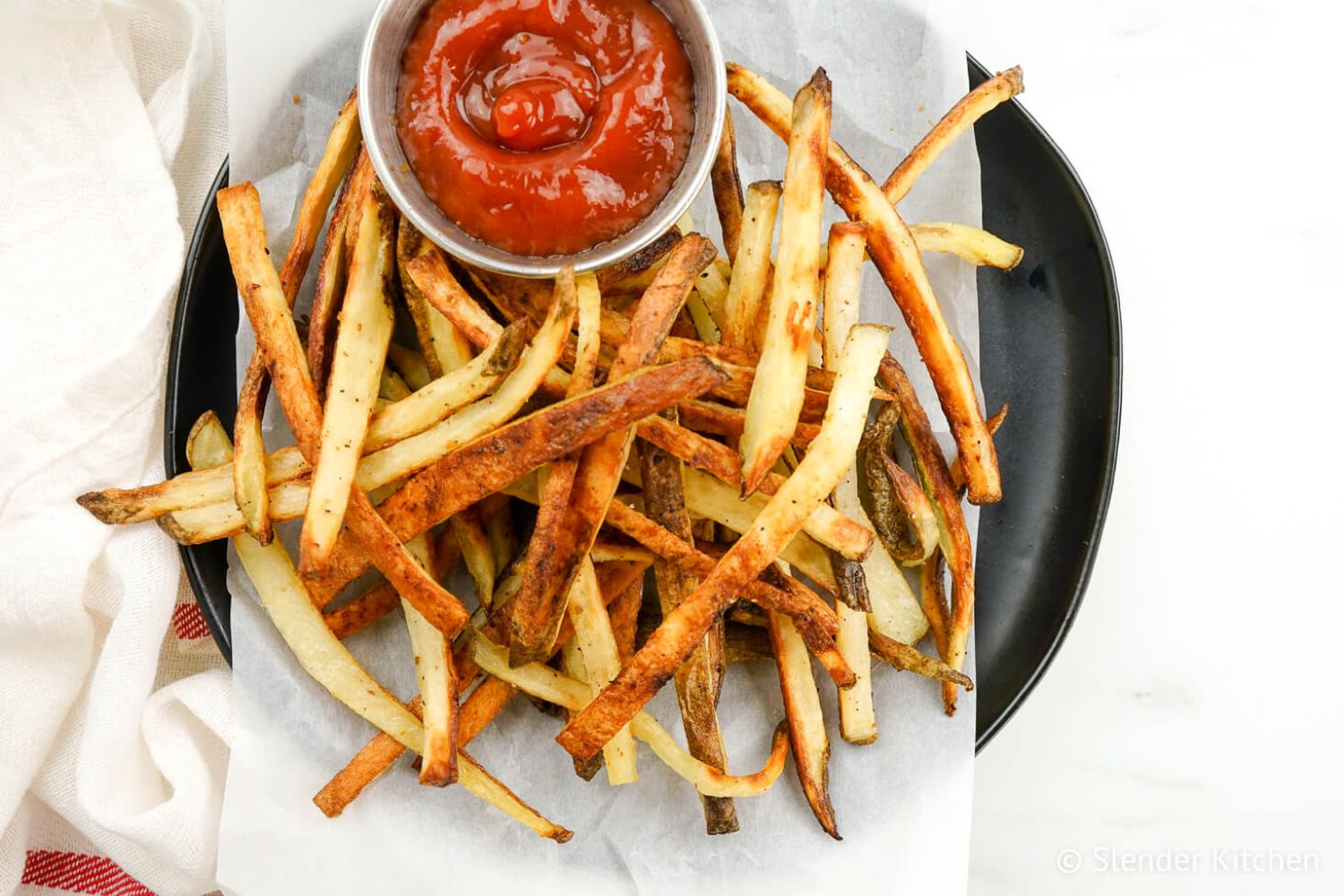 Crispy turnip fries with ketchup on a plate.