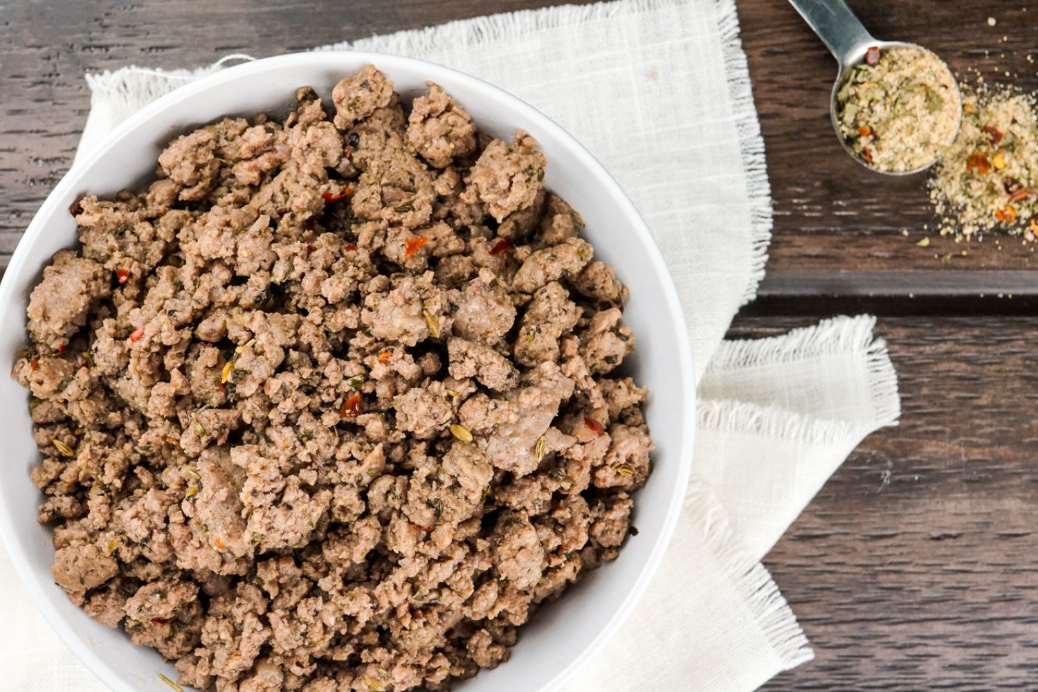 Italian sausage seasoning cooked with ground turkey in a skillet.