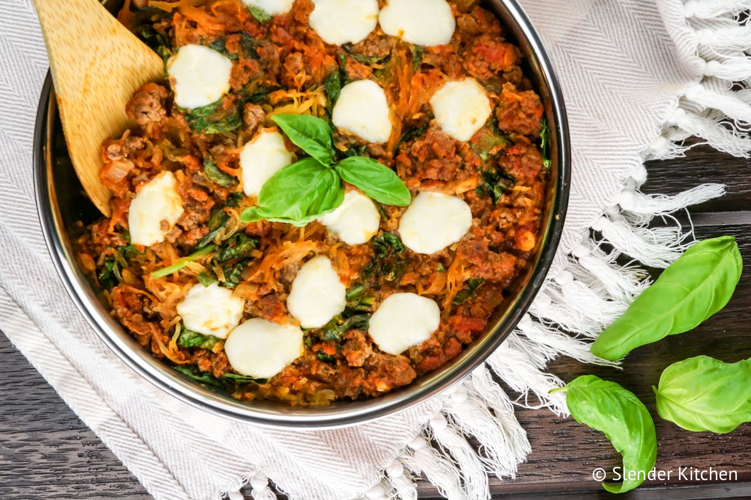 Spaghetti squash casserole with tomatoes, ground beef, and fresh mozzarella cheese.