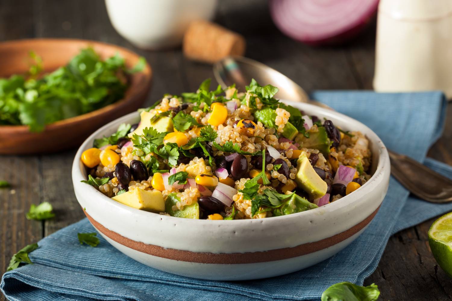 Mexican Quinoa Salad with black beans, cooked quinoa, corn, cilantro, and a creamy avocado dressing.