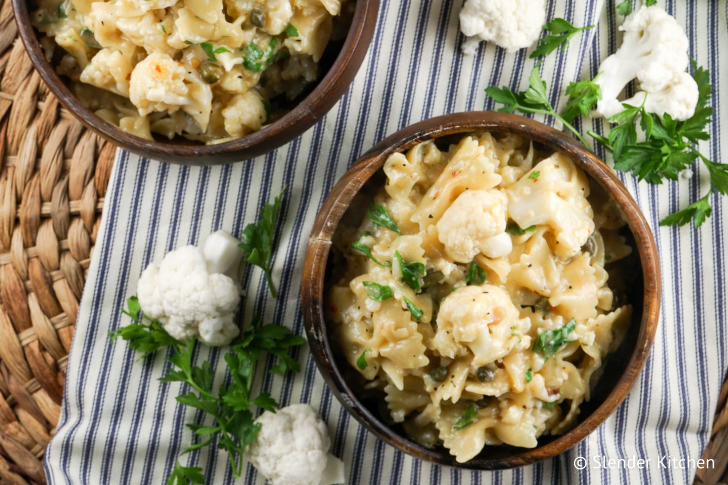 Cauliflower piccata pasta with capers, garlic, lemon, butter, and parsley in a bowl.