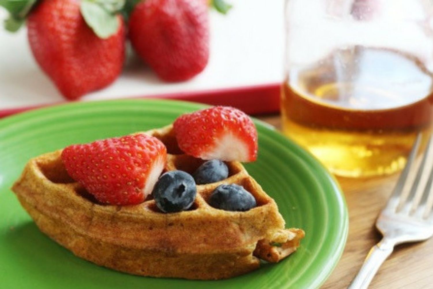 Protein waffles made with oatmeal on a plate with strawberries.