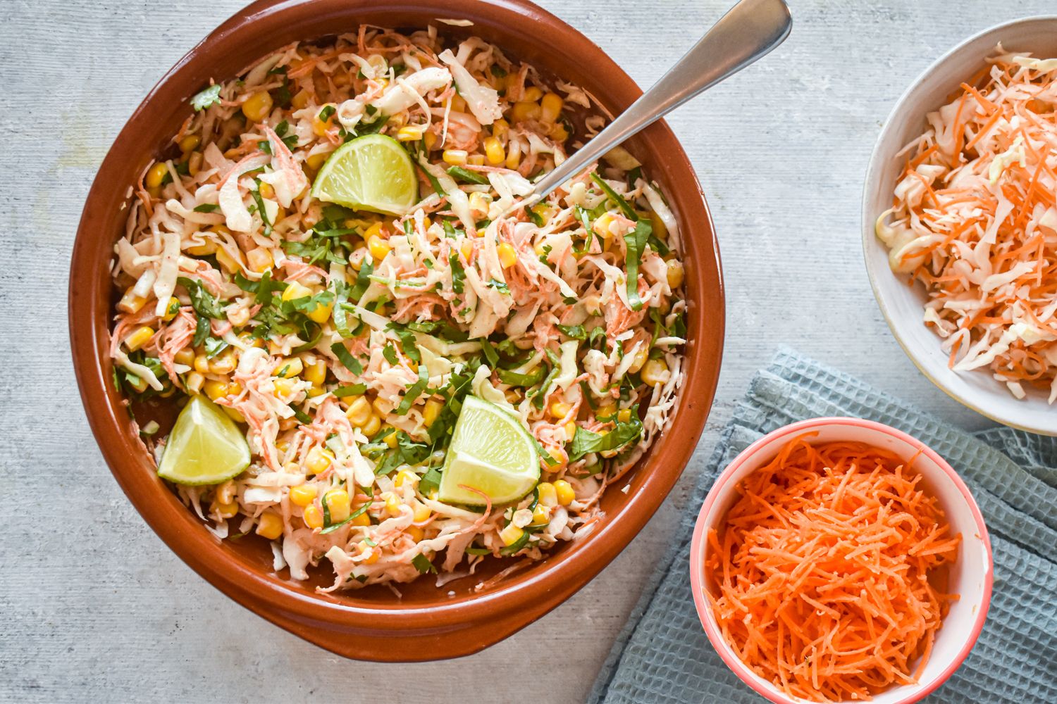 Spicy cabbage slaw with corn and shredded carrots in a creamy lime dressing.