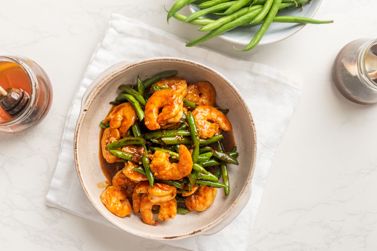 Teriyaki shrimp with green beans in a bowl with homemade teriyaki sauce.