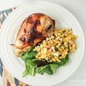 Baked chicken teriyaki with mango salad and greens on a plate.