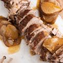 Slow cooker balsamic honey pork tenderloin with cooked pears on a plate.